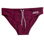 Burgundy men's swim brief flat-lay with white drawcord and gold tips — JWS Swimwear