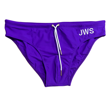 Royal purple men's swim brief flat-lay with white drawcord and gold tips — JWS Swimwear